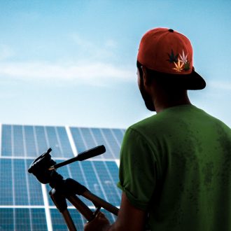 photographer in front of solar panels walliscutt