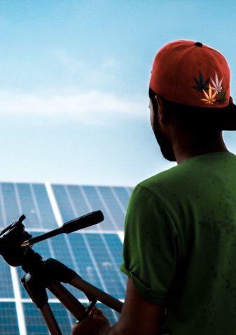 photographer in front of solar panels walliscutt